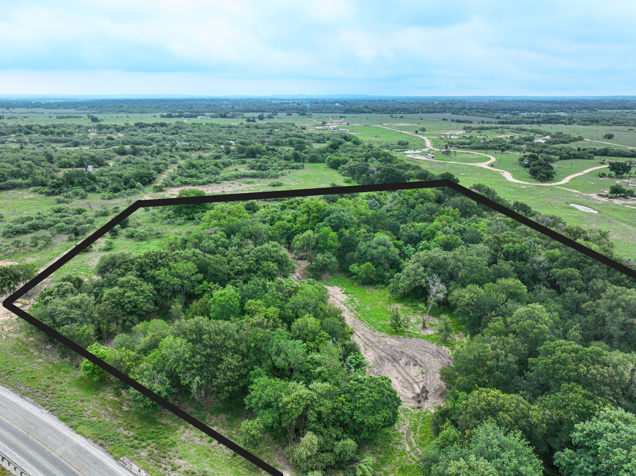 Discover a stunning piece of Central Texas landscape located in Luling, TX. This property offers over 12 acres of land, providing the perfect blend of country living and convenience. Enjoy the serene environment, just minutes from town, while experiencing true rural tranquility. The land boasts enormous shade trees and beautiful creek bottom terrain. Its gentle, sloping topography offers pristine views of the surrounding countryside, making it an ideal spot for those seeking scenic vistas. West Plum Creek runs along the backside of the property, adding to its natural appeal. The property features FM highway frontage, ensuring easy access. Several prime building sites are ready for development, with new fencing and electricity already installed. These improvements make the land immediately usable for various purposes. Situated within 5 minutes of Luling and just 10 minutes from Lockhart, this property provides quick access to nearby towns. It is less than an hour from both Austin and San Antonio, and only about 45 minutes from the Austin International Airport and Circuit of the Americas racetrack. 
NO RESTRICTIONS
AG EXEMPT - WILDLIFE