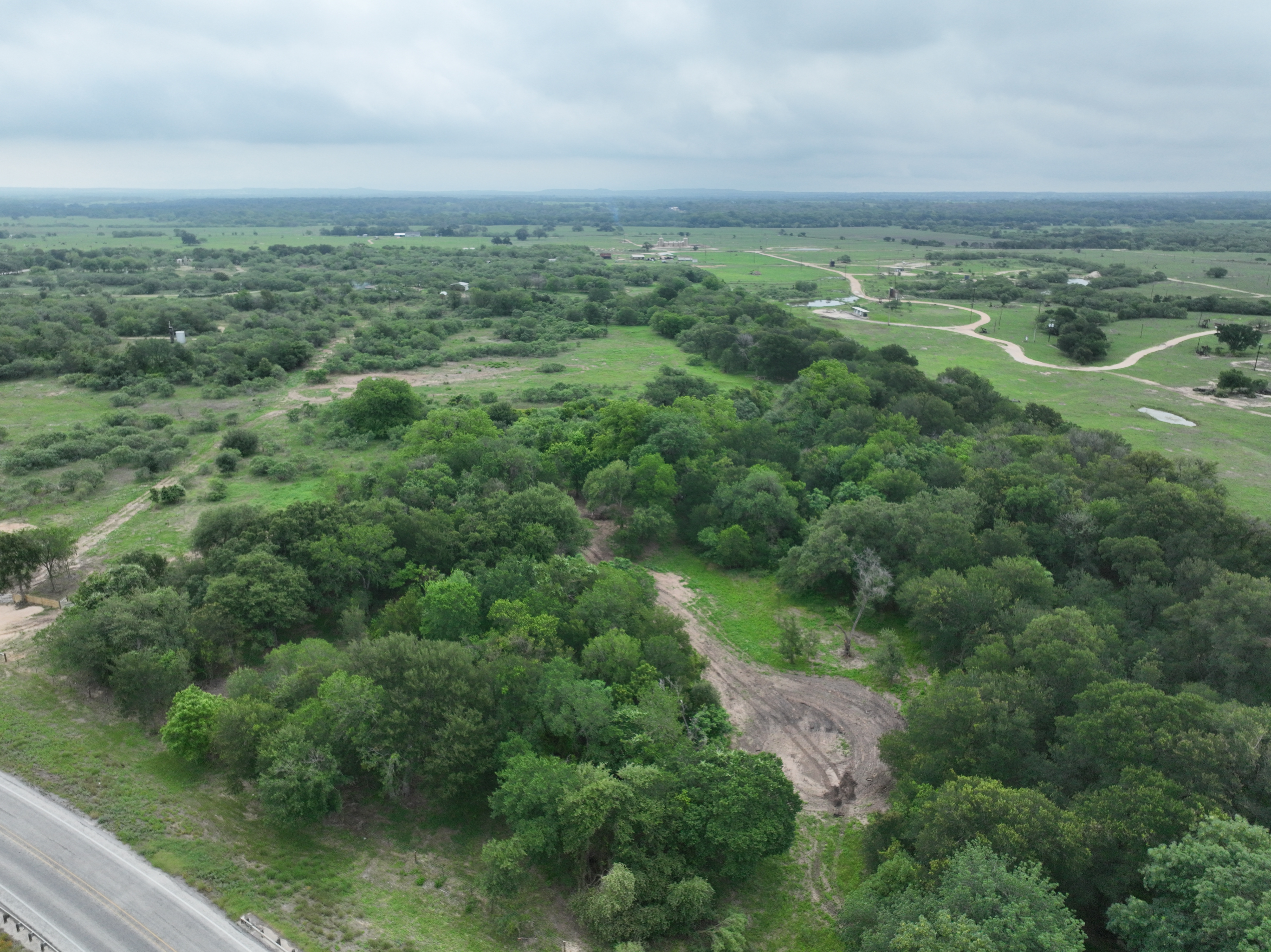 Discover a stunning piece of Central Texas landscape located in Luling, TX. This property offers over 12 acres of land, providing the perfect blend of country living and convenience. Enjoy the serene environment, just minutes from town, while experiencing true rural tranquility. The land boasts enormous shade trees and beautiful creek bottom terrain. Its gentle, sloping topography offers pristine views of the surrounding countryside, making it an ideal spot for those seeking scenic vistas. West Plum Creek runs along the backside of the property, adding to its natural appeal. The property features FM highway frontage, ensuring easy access. Several prime building sites are ready for development, with new fencing and electricity already installed. These improvements make the land immediately usable for various purposes. Situated within 5 minutes of Luling and just 10 minutes from Lockhart, this property provides quick access to nearby towns. It is less than an hour from both Austin and San Antonio, and only about 45 minutes from the Austin International Airport and Circuit of the Americas racetrack. 
NO RESTRICTIONS
AG EXEMPT - WILDLIFE
