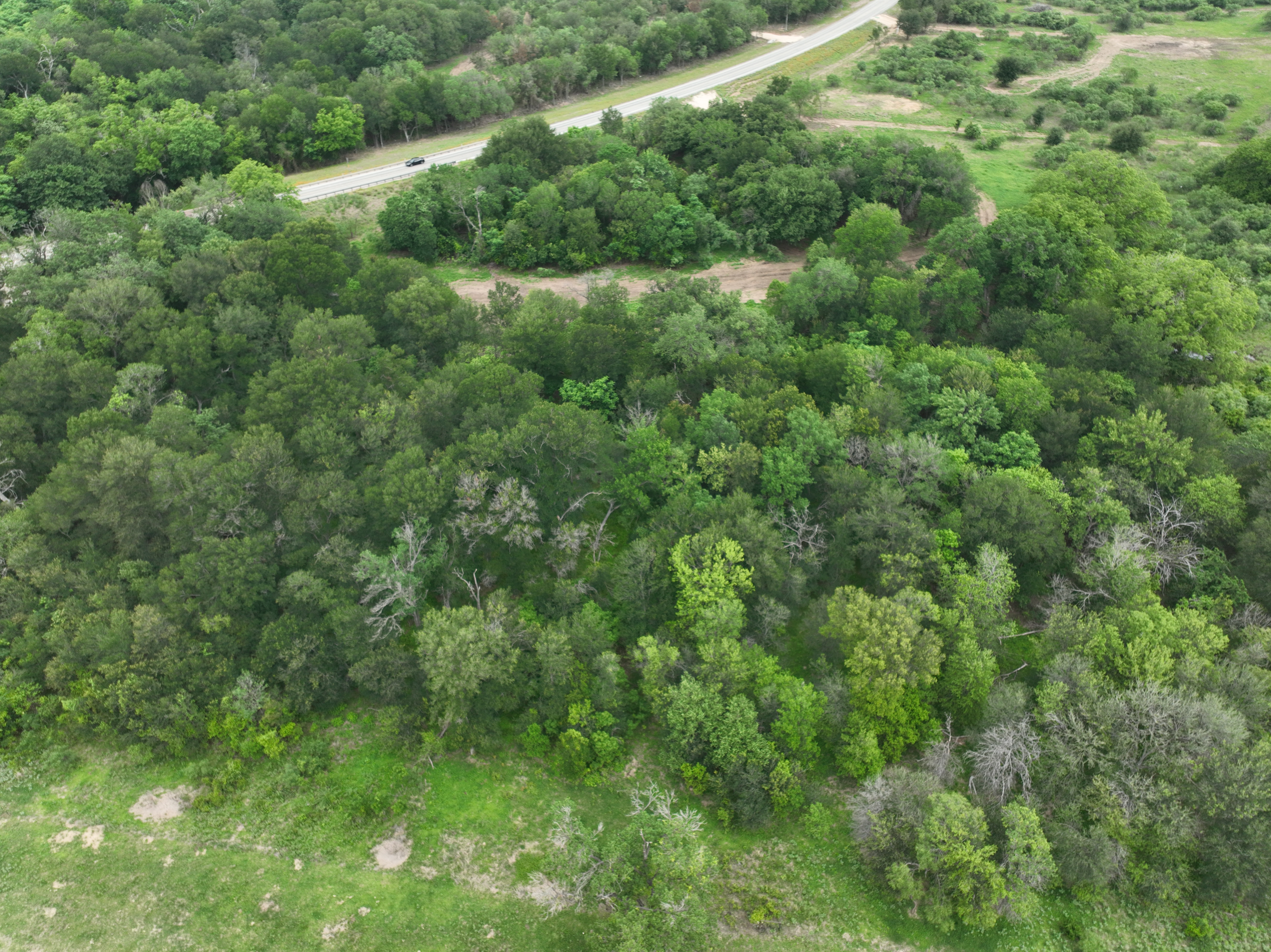 Discover a stunning piece of Central Texas landscape located in Luling, TX. This property offers over 12 acres of land, providing the perfect blend of country living and convenience. Enjoy the serene environment, just minutes from town, while experiencing true rural tranquility. The land boasts enormous shade trees and beautiful creek bottom terrain. Its gentle, sloping topography offers pristine views of the surrounding countryside, making it an ideal spot for those seeking scenic vistas. West Plum Creek runs along the backside of the property, adding to its natural appeal. The property features FM highway frontage, ensuring easy access. Several prime building sites are ready for development, with new fencing and electricity already installed. These improvements make the land immediately usable for various purposes. Situated within 5 minutes of Luling and just 10 minutes from Lockhart, this property provides quick access to nearby towns. It is less than an hour from both Austin and San Antonio, and only about 45 minutes from the Austin International Airport and Circuit of the Americas racetrack. 
NO RESTRICTIONS
AG EXEMPT - WILDLIFE