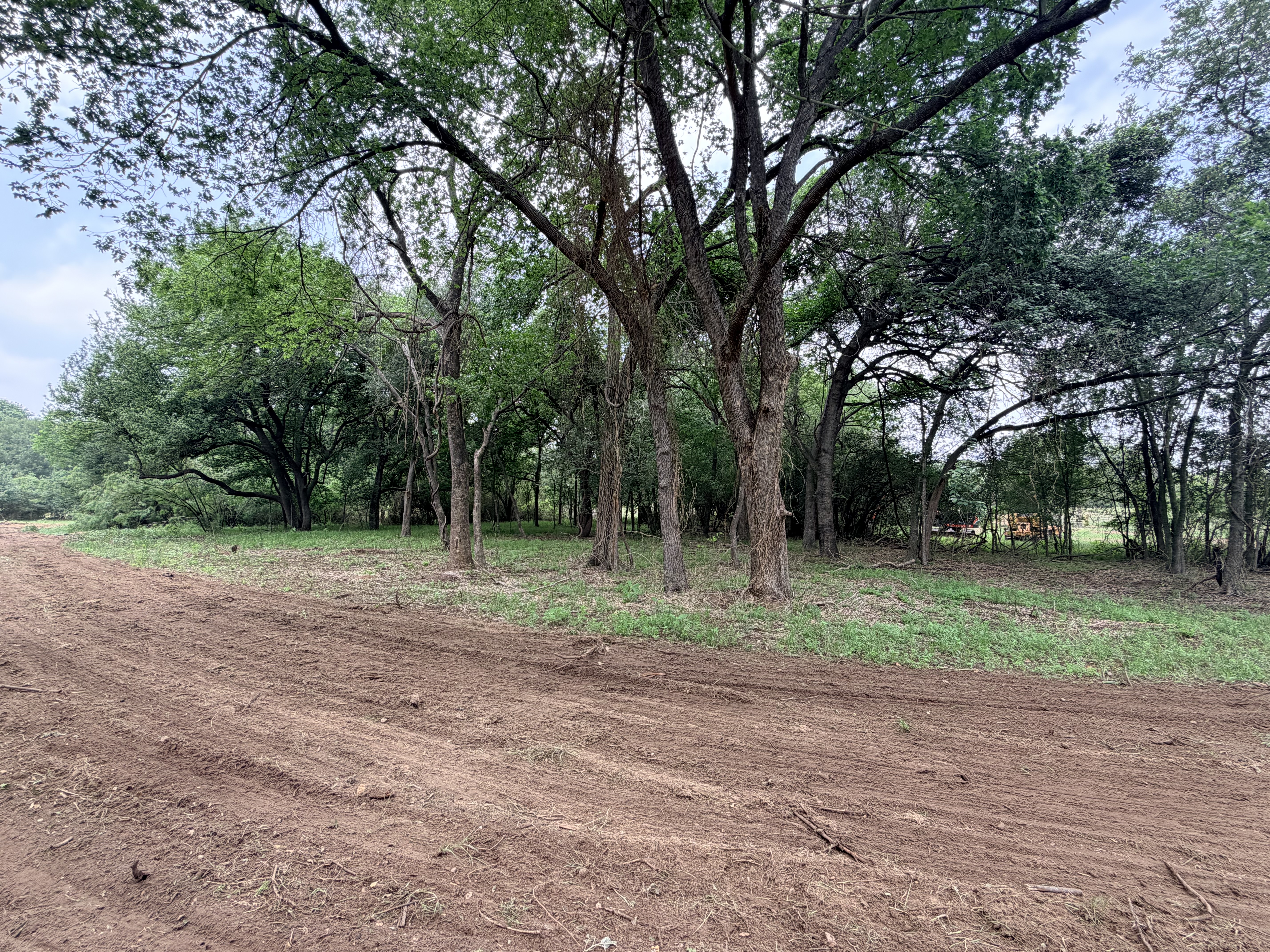 Discover a stunning piece of Central Texas landscape located in Luling, TX. This property offers over 12 acres of land, providing the perfect blend of country living and convenience. Enjoy the serene environment, just minutes from town, while experiencing true rural tranquility. The land boasts enormous shade trees and beautiful creek bottom terrain. Its gentle, sloping topography offers pristine views of the surrounding countryside, making it an ideal spot for those seeking scenic vistas. West Plum Creek runs along the backside of the property, adding to its natural appeal. The property features FM highway frontage, ensuring easy access. Several prime building sites are ready for development, with new fencing and electricity already installed. These improvements make the land immediately usable for various purposes. Situated within 5 minutes of Luling and just 10 minutes from Lockhart, this property provides quick access to nearby towns. It is less than an hour from both Austin and San Antonio, and only about 45 minutes from the Austin International Airport and Circuit of the Americas racetrack. 
NO RESTRICTIONS
AG EXEMPT - WILDLIFE