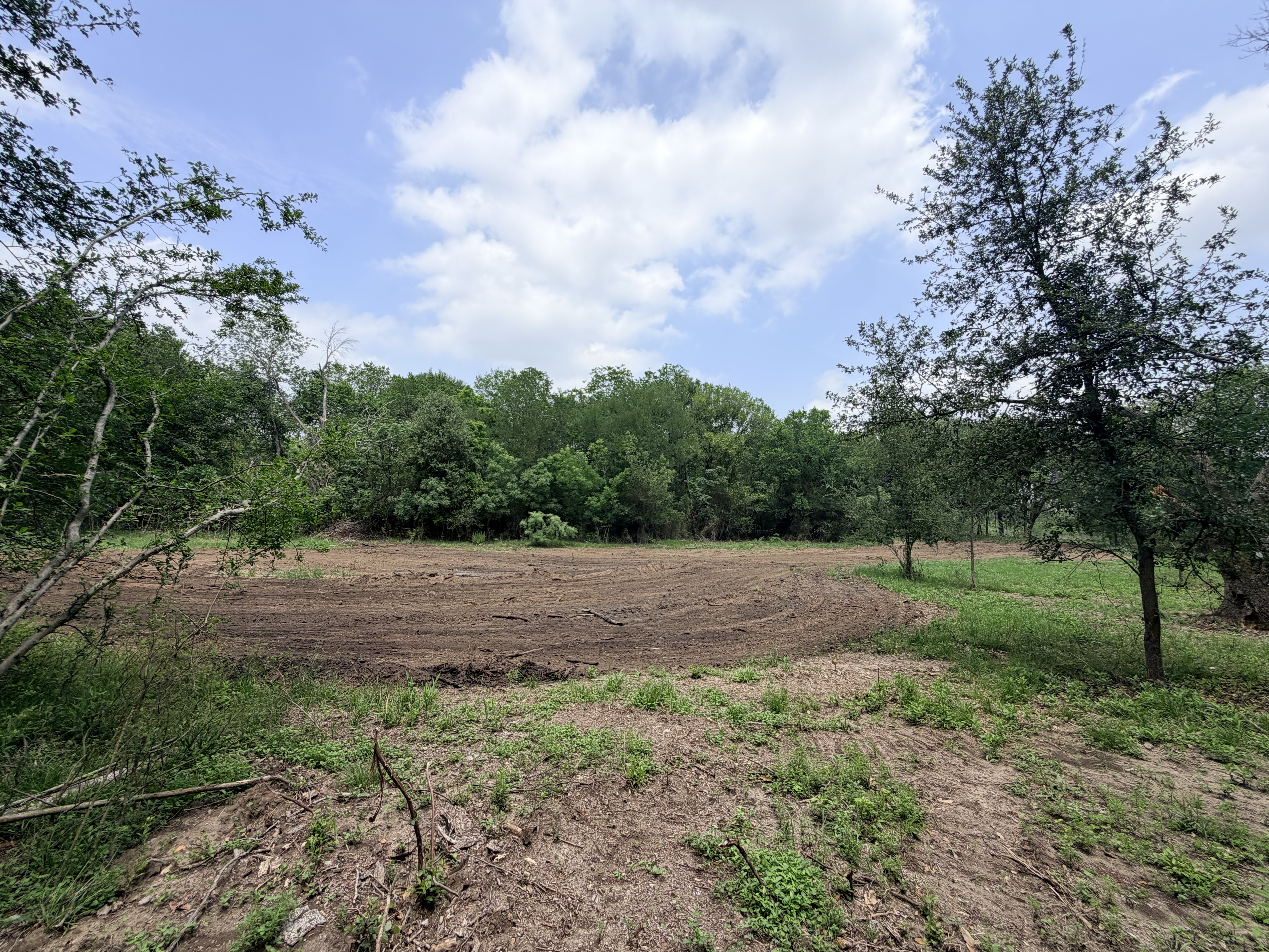 Discover a stunning piece of Central Texas landscape located in Luling, TX. This property offers over 12 acres of land, providing the perfect blend of country living and convenience. Enjoy the serene environment, just minutes from town, while experiencing true rural tranquility. The land boasts enormous shade trees and beautiful creek bottom terrain. Its gentle, sloping topography offers pristine views of the surrounding countryside, making it an ideal spot for those seeking scenic vistas. West Plum Creek runs along the backside of the property, adding to its natural appeal. The property features FM highway frontage, ensuring easy access. Several prime building sites are ready for development, with new fencing and electricity already installed. These improvements make the land immediately usable for various purposes. Situated within 5 minutes of Luling and just 10 minutes from Lockhart, this property provides quick access to nearby towns. It is less than an hour from both Austin and San Antonio, and only about 45 minutes from the Austin International Airport and Circuit of the Americas racetrack. 
NO RESTRICTIONS
AG EXEMPT - WILDLIFE