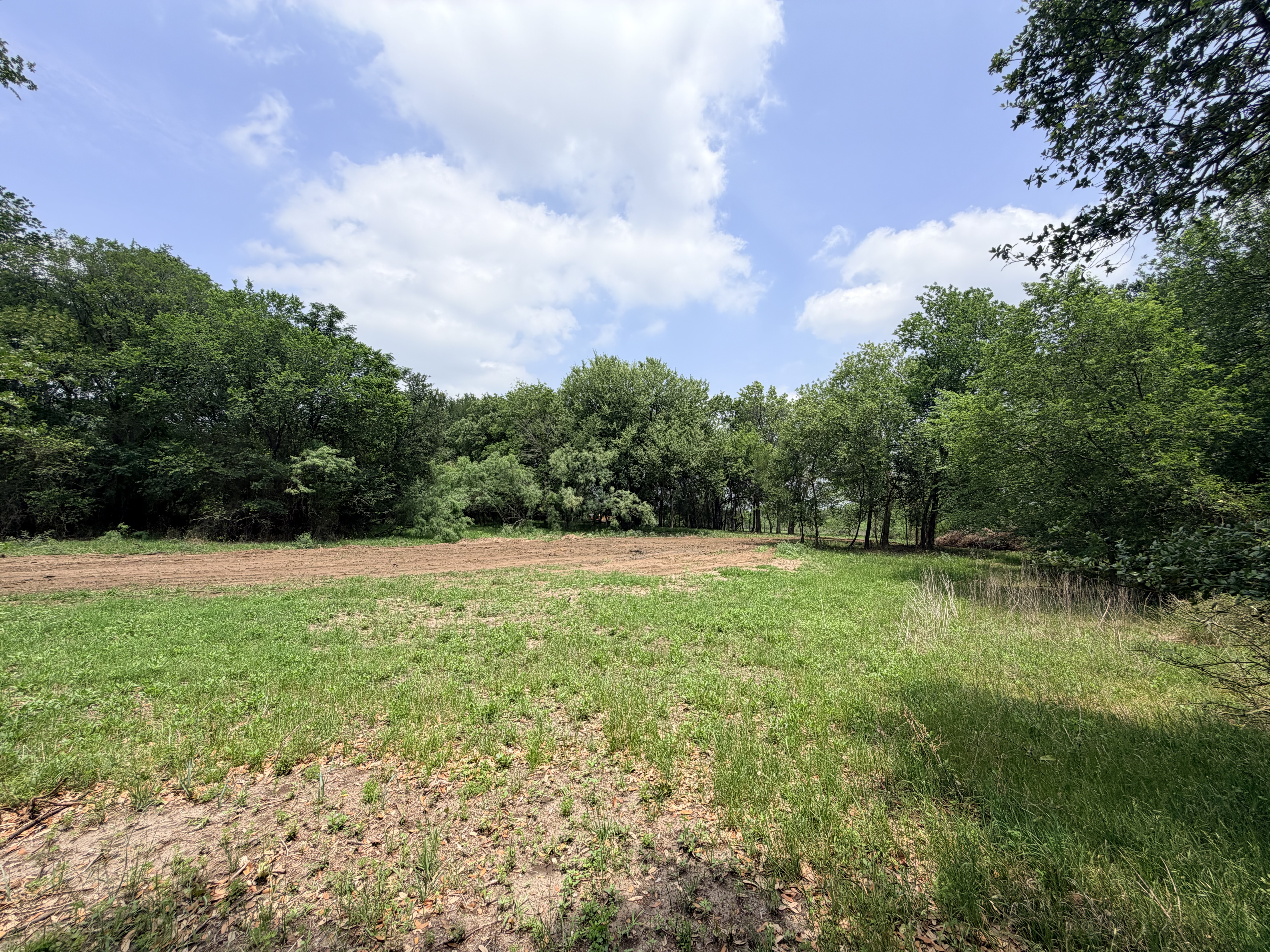 Discover a stunning piece of Central Texas landscape located in Luling, TX. This property offers over 12 acres of land, providing the perfect blend of country living and convenience. Enjoy the serene environment, just minutes from town, while experiencing true rural tranquility. The land boasts enormous shade trees and beautiful creek bottom terrain. Its gentle, sloping topography offers pristine views of the surrounding countryside, making it an ideal spot for those seeking scenic vistas. West Plum Creek runs along the backside of the property, adding to its natural appeal. The property features FM highway frontage, ensuring easy access. Several prime building sites are ready for development, with new fencing and electricity already installed. These improvements make the land immediately usable for various purposes. Situated within 5 minutes of Luling and just 10 minutes from Lockhart, this property provides quick access to nearby towns. It is less than an hour from both Austin and San Antonio, and only about 45 minutes from the Austin International Airport and Circuit of the Americas racetrack. 
NO RESTRICTIONS
AG EXEMPT - WILDLIFE