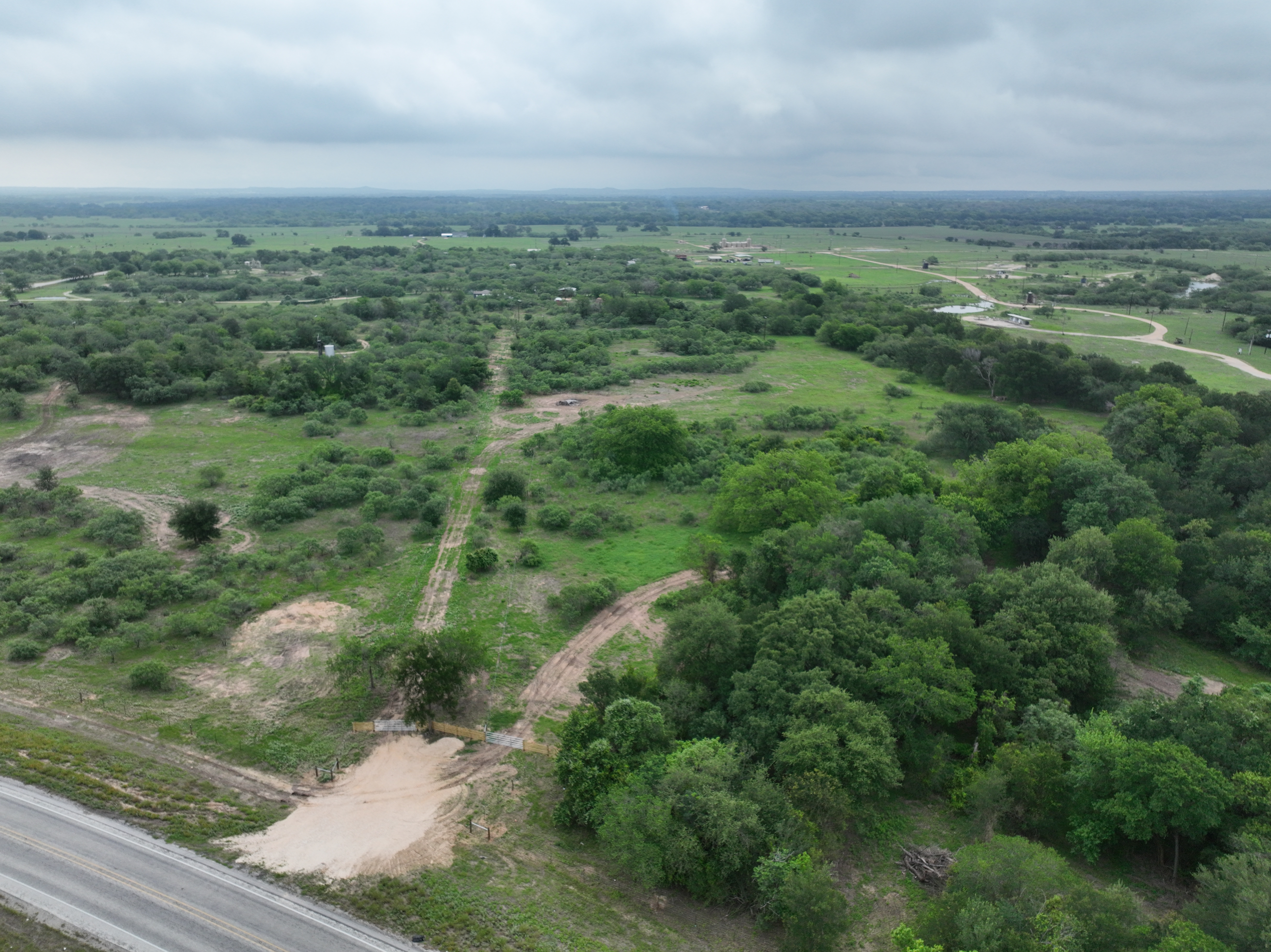 Discover a stunning piece of Central Texas landscape located in Luling, TX. This property offers over 13+ acres of land, providing the perfect blend of country living and convenience. Enjoy the serene environment, just minutes from town, while experiencing true rural tranquility. The land boasts enormous shade trees and beautiful creek bottom terrain. Its gentle, sloping topography offers pristine views of the surrounding countryside, making it an ideal spot for those seeking scenic vistas. West Plum Creek runs along the backside of the property, adding to its natural appeal. The property features FM highway frontage, ensuring easy access. Several prime building sites are ready for development, with new fencing and electricity already installed. These improvements make the land immediately usable for various purposes. Situated within 5 minutes of Luling and just 10 minutes from Lockhart, this property provides quick access to nearby towns. It is less than an hour from both Austin and San Antonio, and only about 45 minutes from the Austin International Airport and Circuit of the Americas racetrack. 
NO RESTRICTIONS
AG EXEMPT - WILDLIFE