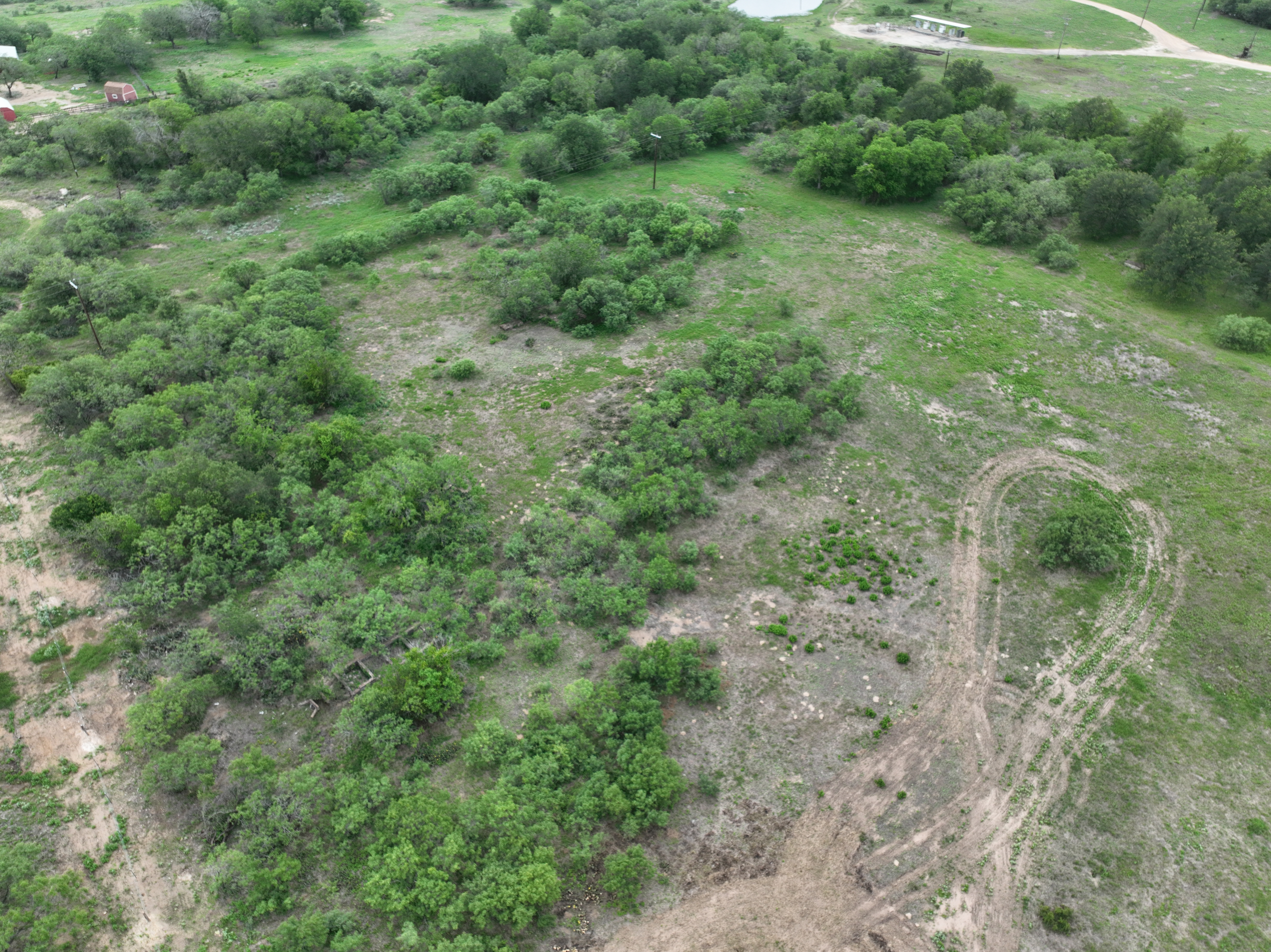 Discover a stunning piece of Central Texas landscape located in Luling, TX. This property offers over 13+ acres of land, providing the perfect blend of country living and convenience. Enjoy the serene environment, just minutes from town, while experiencing true rural tranquility. The land boasts enormous shade trees and beautiful creek bottom terrain. Its gentle, sloping topography offers pristine views of the surrounding countryside, making it an ideal spot for those seeking scenic vistas. West Plum Creek runs along the backside of the property, adding to its natural appeal. The property features FM highway frontage, ensuring easy access. Several prime building sites are ready for development, with new fencing and electricity already installed. These improvements make the land immediately usable for various purposes. Situated within 5 minutes of Luling and just 10 minutes from Lockhart, this property provides quick access to nearby towns. It is less than an hour from both Austin and San Antonio, and only about 45 minutes from the Austin International Airport and Circuit of the Americas racetrack. 
NO RESTRICTIONS
AG EXEMPT - WILDLIFE