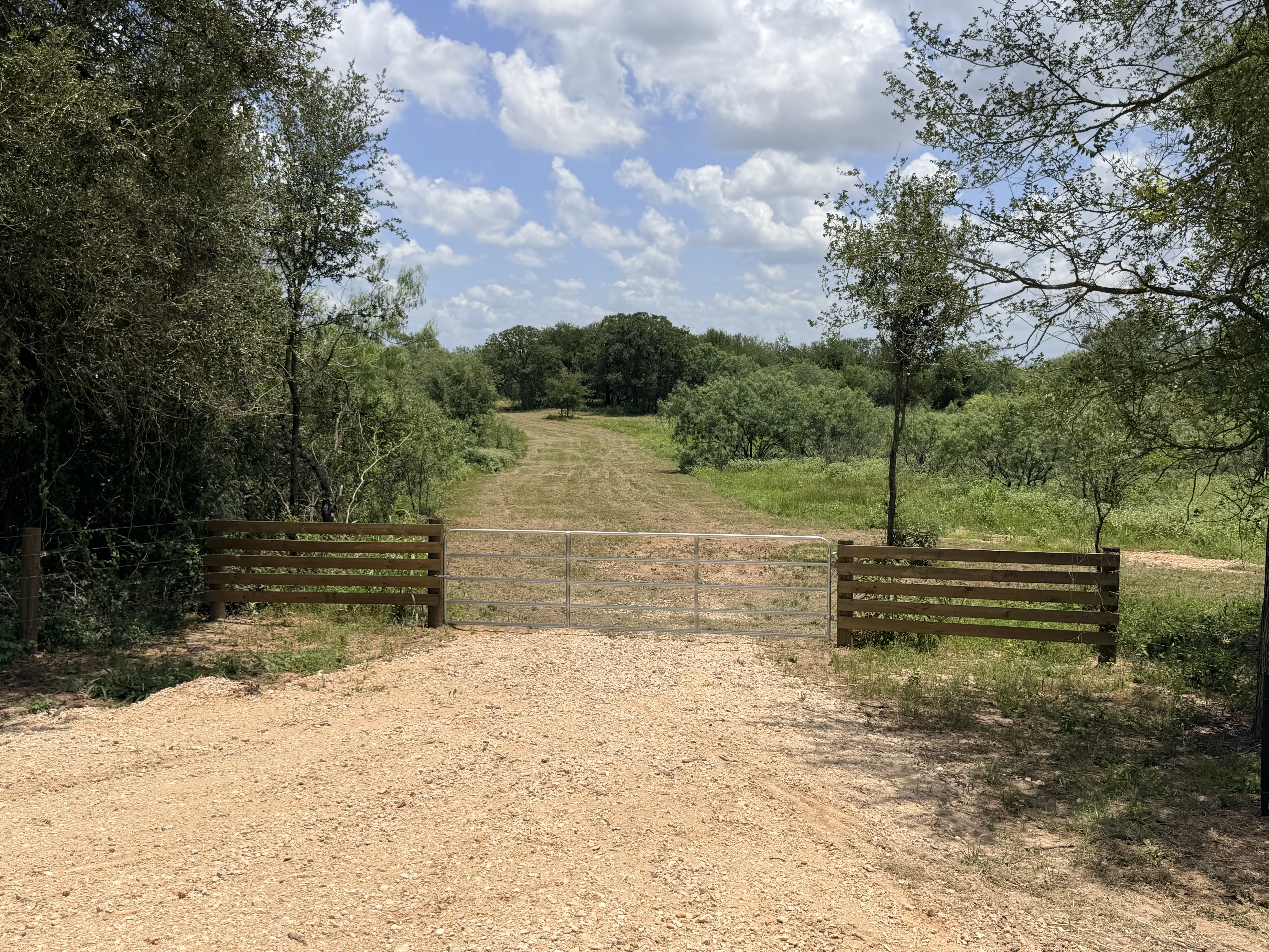 Discover a stunning piece of Central Texas landscape located in Luling, TX. This property offers over 12 acres of land, providing the perfect blend of country living and convenience. Enjoy the serene environment, just minutes from town, while experiencing true rural tranquility. The land boasts enormous shade trees and beautiful creek bottom terrain. Its gentle, sloping topography offers pristine views of the surrounding countryside, making it an ideal spot for those seeking scenic vistas. West Plum Creek runs along the backside of the property, adding to its natural appeal. The property features FM highway frontage, ensuring easy access. Several prime building sites are ready for development, with new fencing and electricity already installed. These improvements make the land immediately usable for various purposes. Situated within 5 minutes of Luling and just 10 minutes from Lockhart, this property provides quick access to nearby towns. It is less than an hour from both Austin and San Antonio, and only about 45 minutes from the Austin International Airport and Circuit of the Americas racetrack. 
NO RESTRICTIONS
AG EXEMPT - WILDLIFE