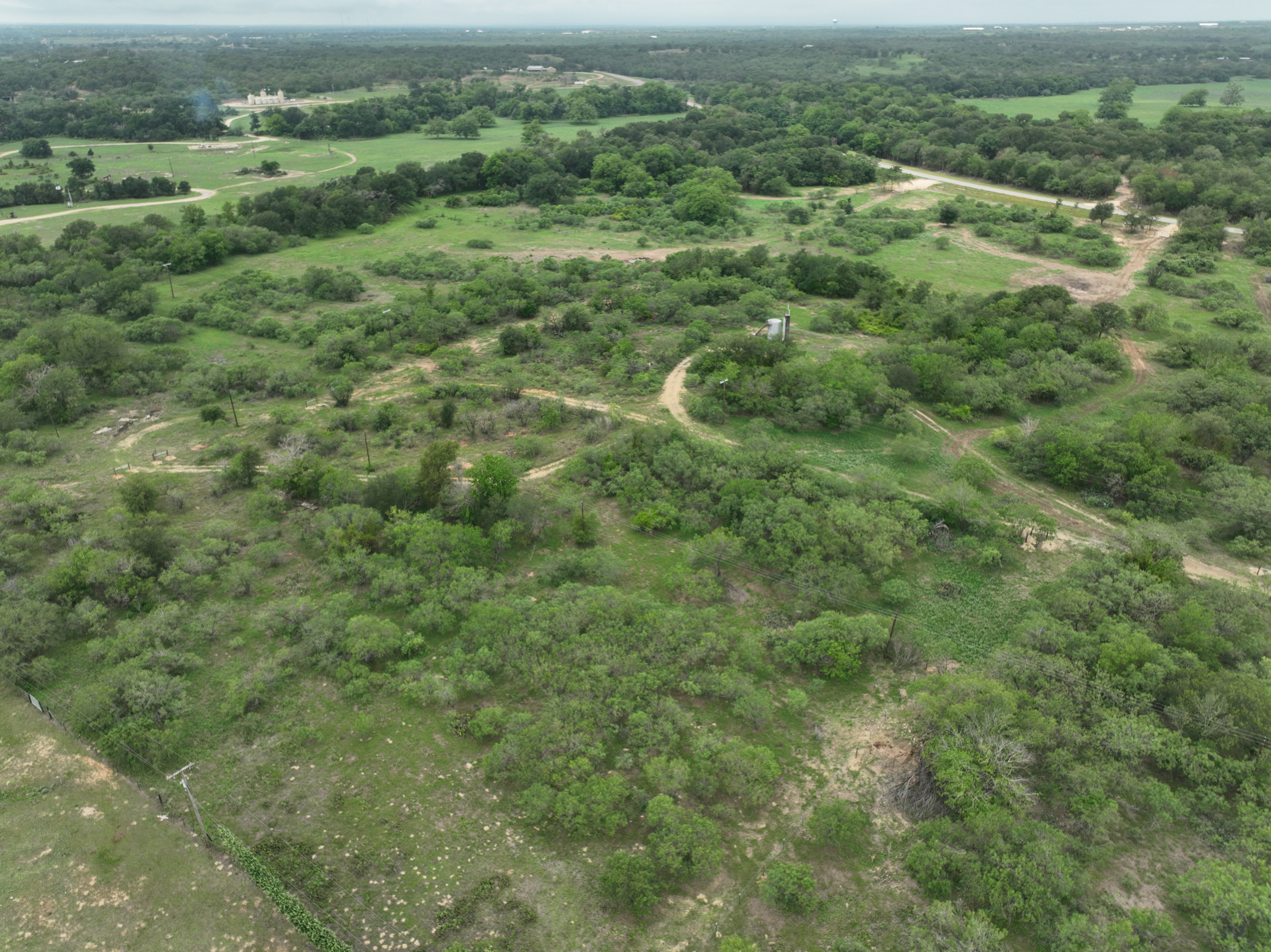 Discover a stunning piece of Central Texas landscape located in Luling, TX. This property offers over 12 acres of land, providing the perfect blend of country living and convenience. Enjoy the serene environment, just minutes from town, while experiencing true rural tranquility. The land boasts enormous shade trees and beautiful creek bottom terrain. Its gentle, sloping topography offers pristine views of the surrounding countryside, making it an ideal spot for those seeking scenic vistas. West Plum Creek runs along the backside of the property, adding to its natural appeal. The property features FM highway frontage, ensuring easy access. Several prime building sites are ready for development, with new fencing and electricity already installed. These improvements make the land immediately usable for various purposes. Situated within 5 minutes of Luling and just 10 minutes from Lockhart, this property provides quick access to nearby towns. It is less than an hour from both Austin and San Antonio, and only about 45 minutes from the Austin International Airport and Circuit of the Americas racetrack. 
NO RESTRICTIONS
AG EXEMPT - WILDLIFE
