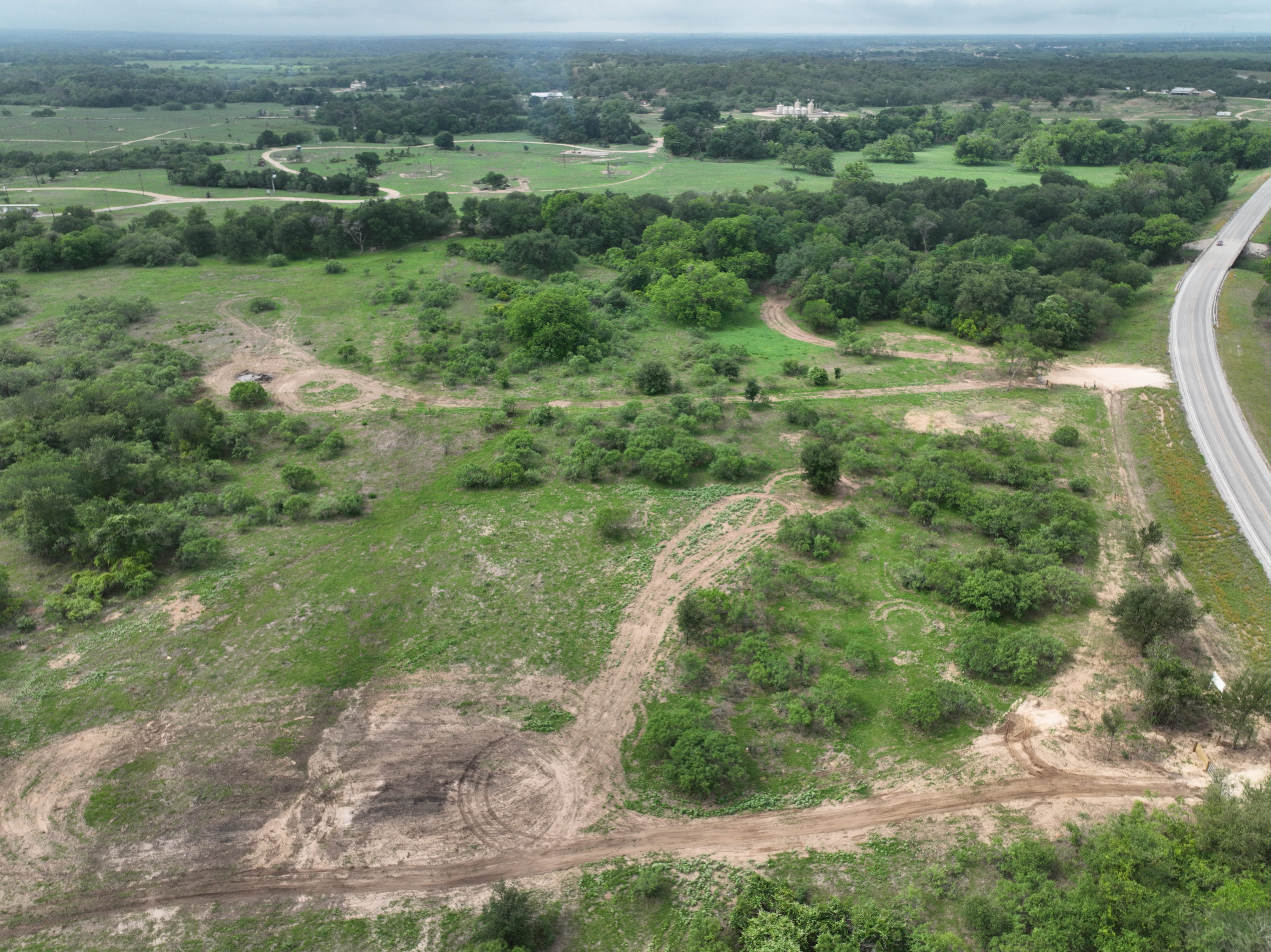 Discover a stunning piece of Central Texas landscape located in Luling, TX. This property offers over 12 acres of land, providing the perfect blend of country living and convenience. Enjoy the serene environment, just minutes from town, while experiencing true rural tranquility. The land boasts enormous shade trees and beautiful creek bottom terrain. Its gentle, sloping topography offers pristine views of the surrounding countryside, making it an ideal spot for those seeking scenic vistas. West Plum Creek runs along the backside of the property, adding to its natural appeal. The property features FM highway frontage, ensuring easy access. Several prime building sites are ready for development, with new fencing and electricity already installed. These improvements make the land immediately usable for various purposes. Situated within 5 minutes of Luling and just 10 minutes from Lockhart, this property provides quick access to nearby towns. It is less than an hour from both Austin and San Antonio, and only about 45 minutes from the Austin International Airport and Circuit of the Americas racetrack. 
NO RESTRICTIONS
AG EXEMPT - WILDLIFE