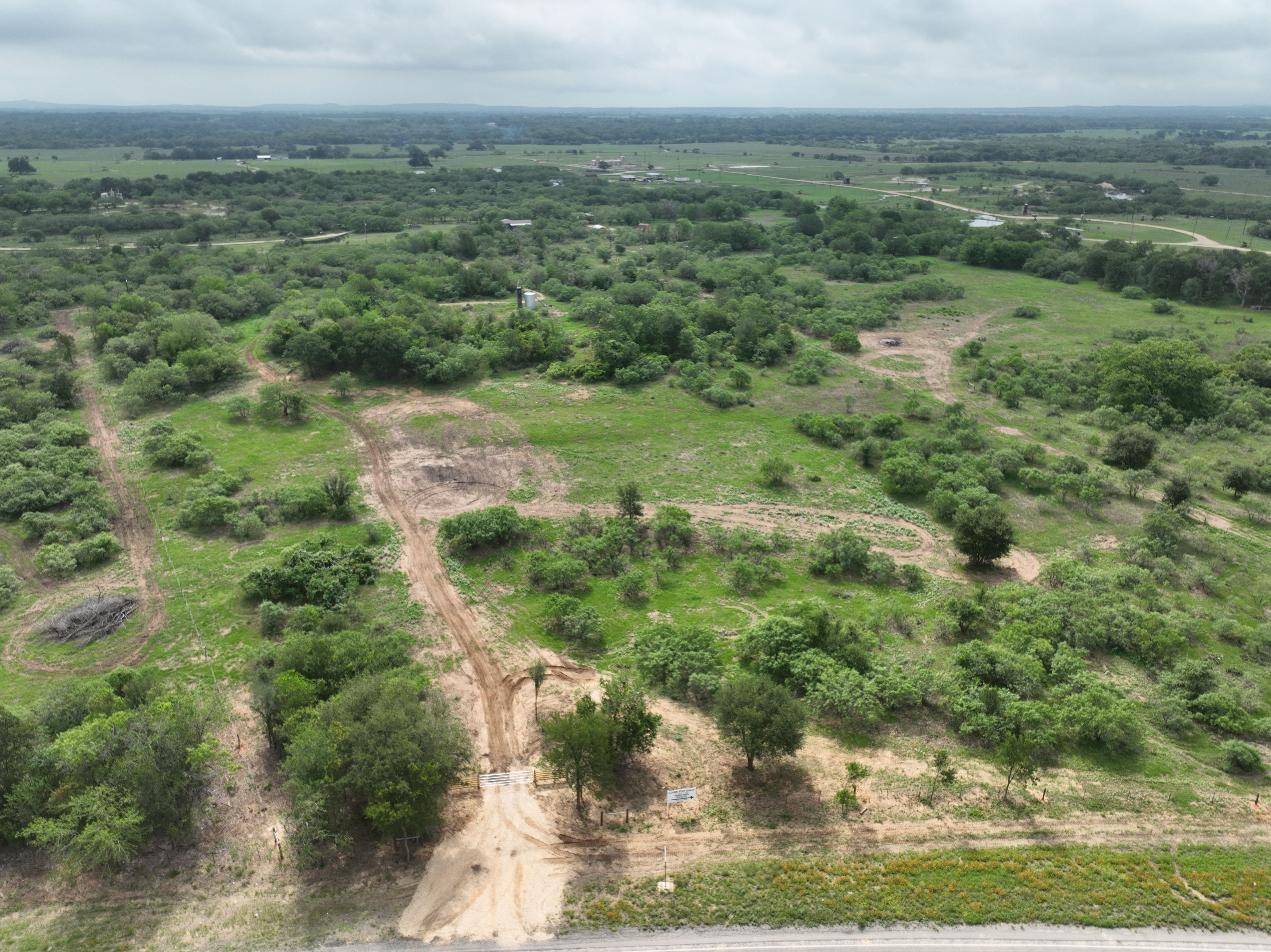 Discover a stunning piece of Central Texas landscape located in Luling, TX. This property offers over 12 acres of land, providing the perfect blend of country living and convenience. Enjoy the serene environment, just minutes from town, while experiencing true rural tranquility. The land boasts enormous shade trees and beautiful creek bottom terrain. Its gentle, sloping topography offers pristine views of the surrounding countryside, making it an ideal spot for those seeking scenic vistas. West Plum Creek runs along the backside of the property, adding to its natural appeal. The property features FM highway frontage, ensuring easy access. Several prime building sites are ready for development, with new fencing and electricity already installed. These improvements make the land immediately usable for various purposes. Situated within 5 minutes of Luling and just 10 minutes from Lockhart, this property provides quick access to nearby towns. It is less than an hour from both Austin and San Antonio, and only about 45 minutes from the Austin International Airport and Circuit of the Americas racetrack. 
NO RESTRICTIONS
AG EXEMPT - WILDLIFE