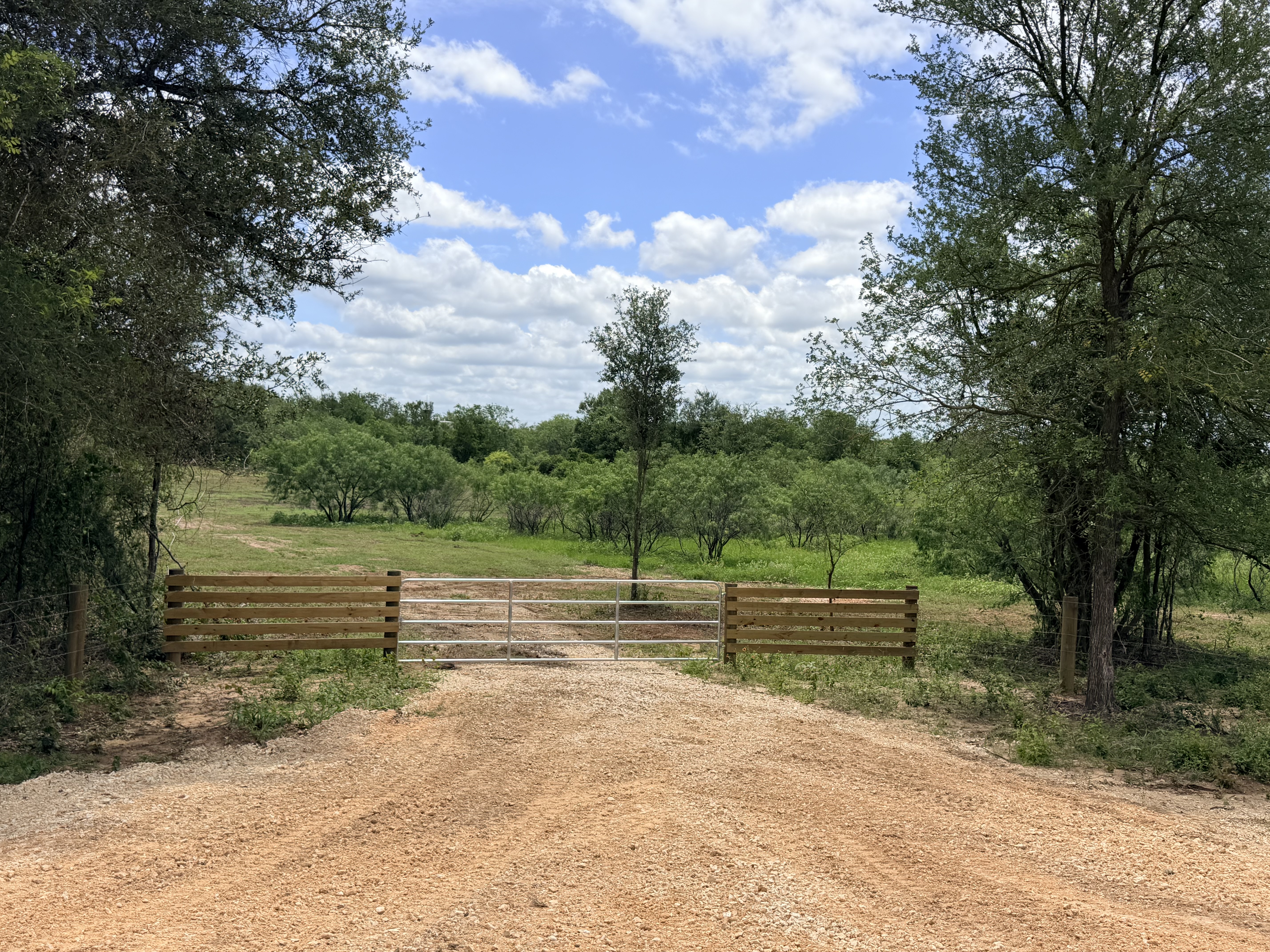 Discover a stunning piece of Central Texas landscape located in Luling, TX. This property offers over 12 acres of land, providing the perfect blend of country living and convenience. Enjoy the serene environment, just minutes from town, while experiencing true rural tranquility. The land boasts enormous shade trees and beautiful creek bottom terrain. Its gentle, sloping topography offers pristine views of the surrounding countryside, making it an ideal spot for those seeking scenic vistas. West Plum Creek runs along the backside of the property, adding to its natural appeal. The property features FM highway frontage, ensuring easy access. Several prime building sites are ready for development, with new fencing and electricity already installed. These improvements make the land immediately usable for various purposes. Situated within 5 minutes of Luling and just 10 minutes from Lockhart, this property provides quick access to nearby towns. It is less than an hour from both Austin and San Antonio, and only about 45 minutes from the Austin International Airport and Circuit of the Americas racetrack. 
NO RESTRICTIONS
AG EXEMPT - WILDLIFE