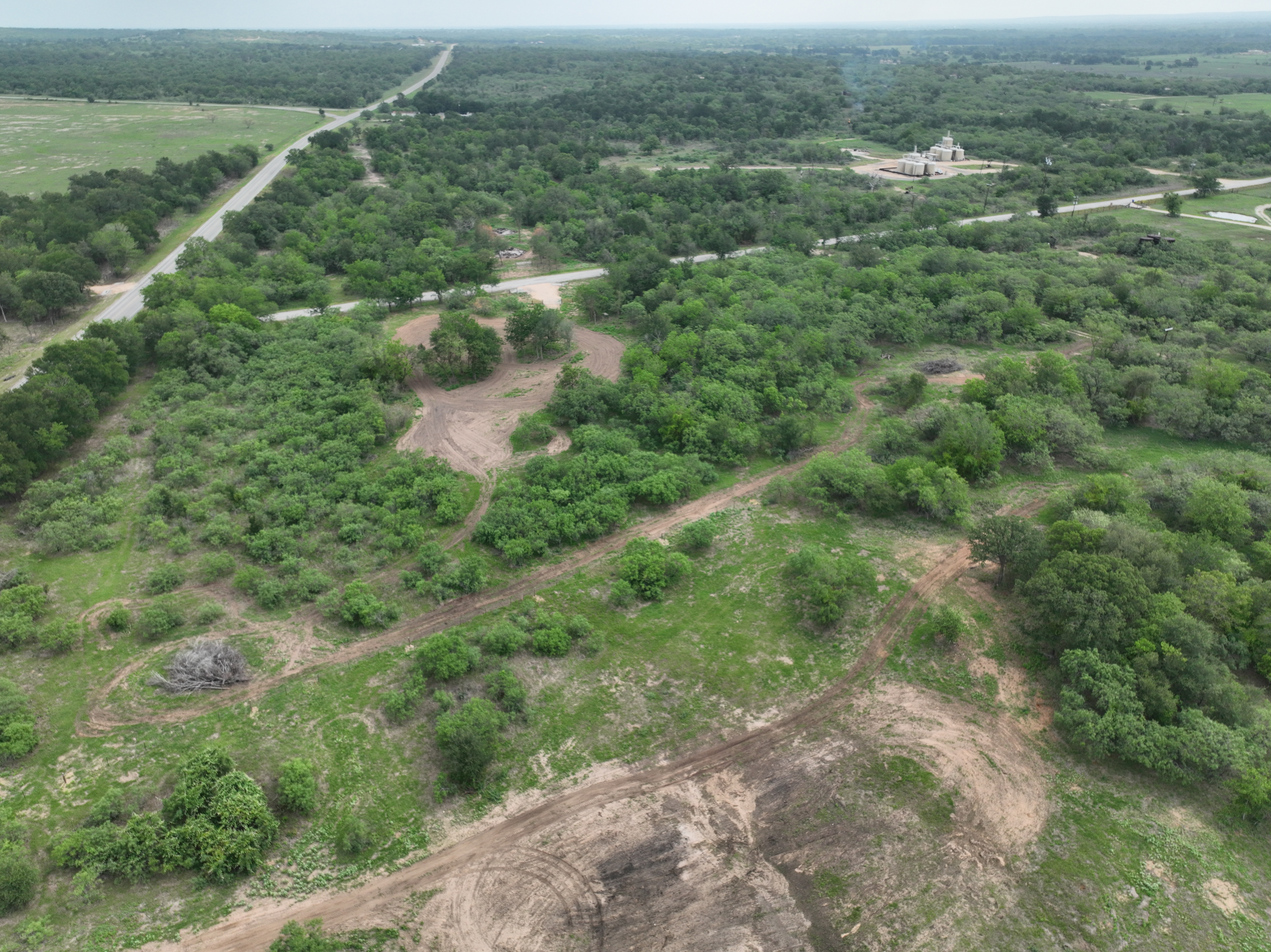 Discover a stunning piece of Central Texas landscape located in Luling, TX. This property offers over 12 acres of land, providing the perfect blend of country living and convenience. Enjoy the serene environment, just minutes from town, while experiencing true rural tranquility. The land boasts enormous shade trees and beautiful creek bottom terrain. Its gentle, sloping topography offers pristine views of the surrounding countryside, making it an ideal spot for those seeking scenic vistas. West Plum Creek runs along the backside of the property, adding to its natural appeal. The property features FM highway frontage, ensuring easy access. Several prime building sites are ready for development, with new fencing and electricity already installed. These improvements make the land immediately usable for various purposes. Situated within 5 minutes of Luling and just 10 minutes from Lockhart, this property provides quick access to nearby towns. It is less than an hour from both Austin and San Antonio, and only about 45 minutes from the Austin International Airport and Circuit of the Americas racetrack. 
NO RESTRICTIONS
AG EXEMPT - WILDLIFE