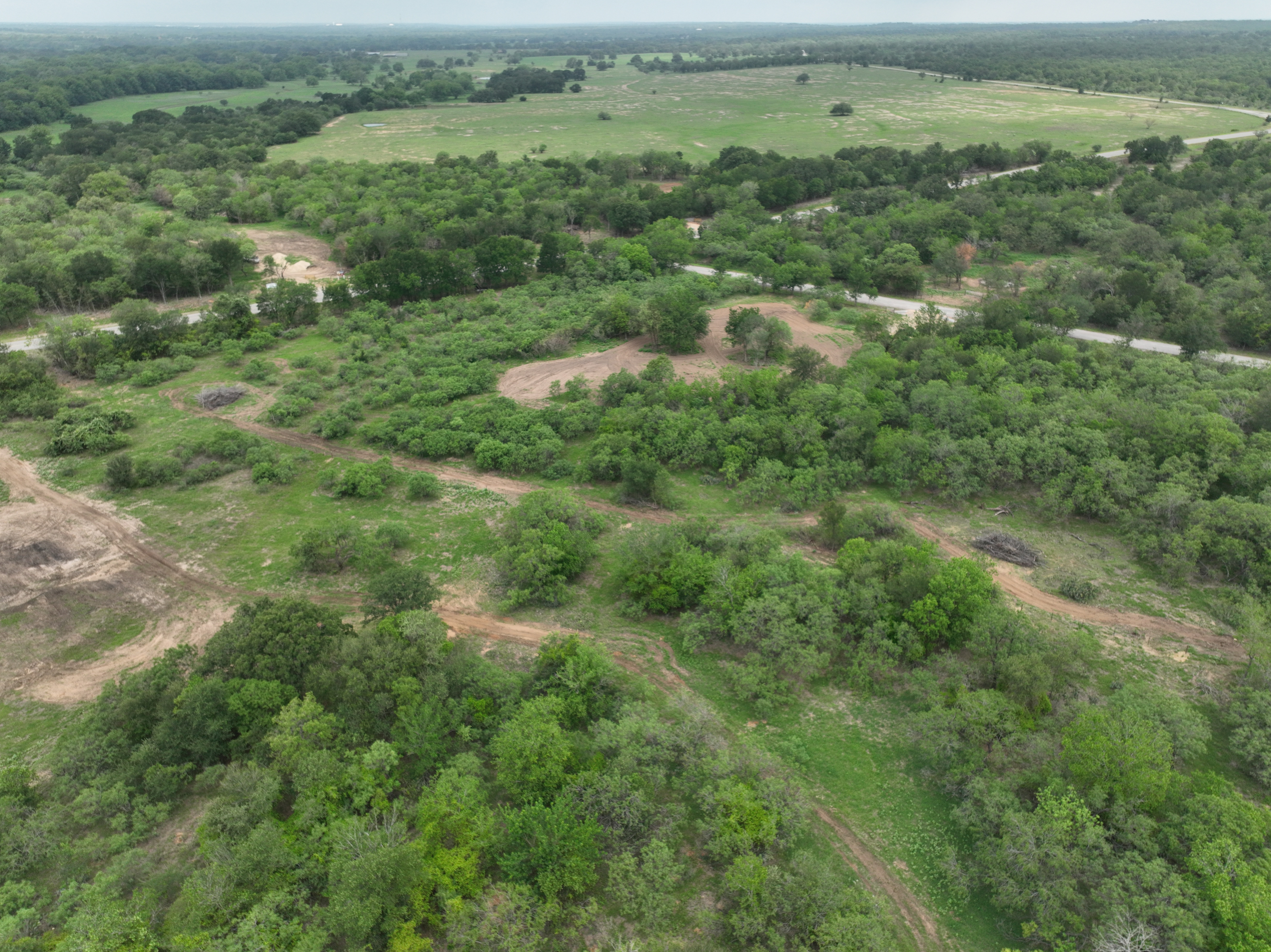 Discover a stunning piece of Central Texas landscape located in Luling, TX. This property offers over 12 acres of land, providing the perfect blend of country living and convenience. Enjoy the serene environment, just minutes from town, while experiencing true rural tranquility. The land boasts enormous shade trees and beautiful creek bottom terrain. Its gentle, sloping topography offers pristine views of the surrounding countryside, making it an ideal spot for those seeking scenic vistas. West Plum Creek runs along the backside of the property, adding to its natural appeal. The property features FM highway frontage, ensuring easy access. Several prime building sites are ready for development, with new fencing and electricity already installed. These improvements make the land immediately usable for various purposes. Situated within 5 minutes of Luling and just 10 minutes from Lockhart, this property provides quick access to nearby towns. It is less than an hour from both Austin and San Antonio, and only about 45 minutes from the Austin International Airport and Circuit of the Americas racetrack. 
NO RESTRICTIONS
AG EXEMPT - WILDLIFE