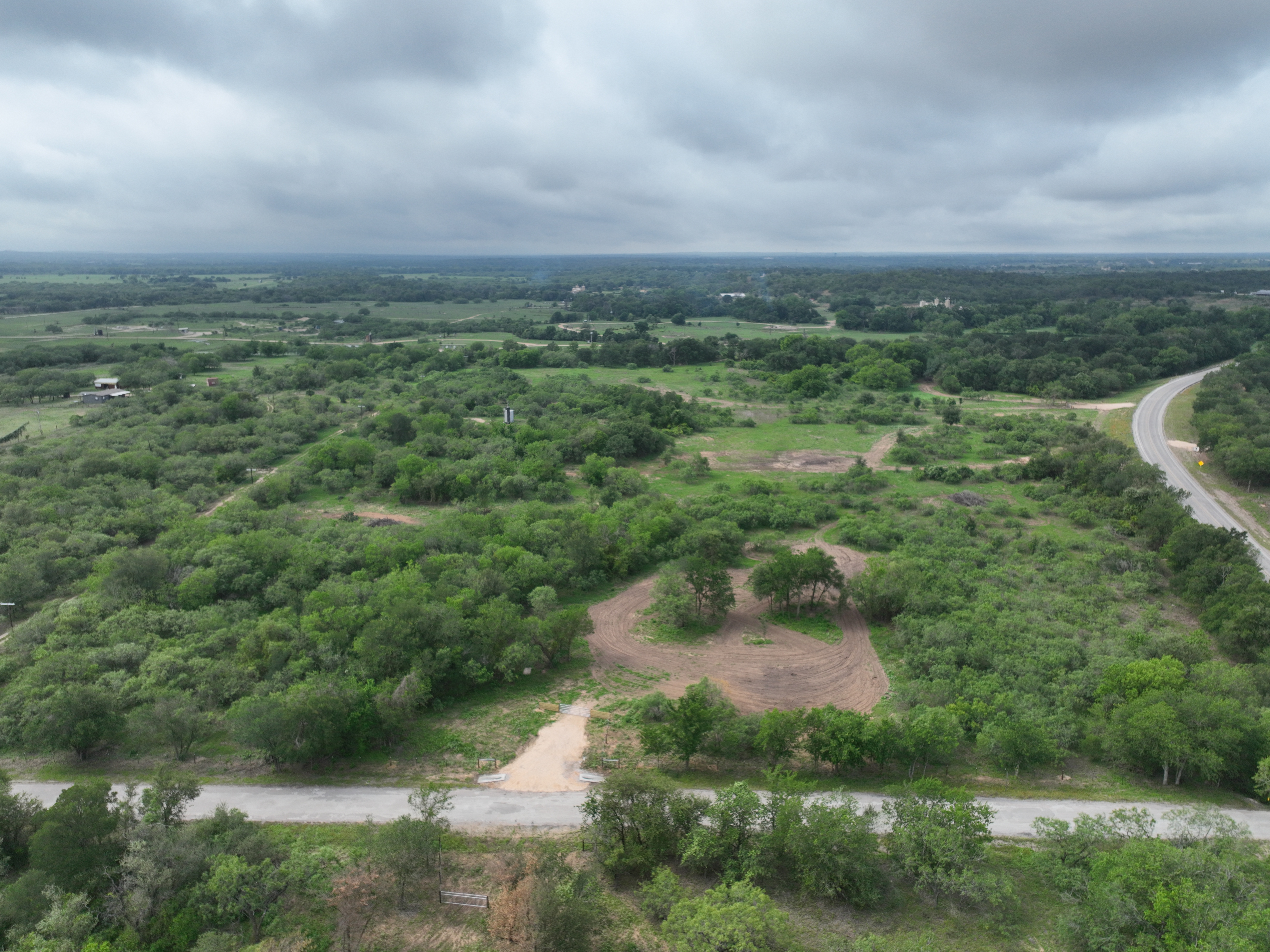 Discover a stunning piece of Central Texas landscape located in Luling, TX. This property offers over 12 acres of land, providing the perfect blend of country living and convenience. Enjoy the serene environment, just minutes from town, while experiencing true rural tranquility. The land boasts enormous shade trees and beautiful creek bottom terrain. Its gentle, sloping topography offers pristine views of the surrounding countryside, making it an ideal spot for those seeking scenic vistas. West Plum Creek runs along the backside of the property, adding to its natural appeal. The property features FM highway frontage, ensuring easy access. Several prime building sites are ready for development, with new fencing and electricity already installed. These improvements make the land immediately usable for various purposes. Situated within 5 minutes of Luling and just 10 minutes from Lockhart, this property provides quick access to nearby towns. It is less than an hour from both Austin and San Antonio, and only about 45 minutes from the Austin International Airport and Circuit of the Americas racetrack. 
NO RESTRICTIONS
AG EXEMPT - WILDLIFE