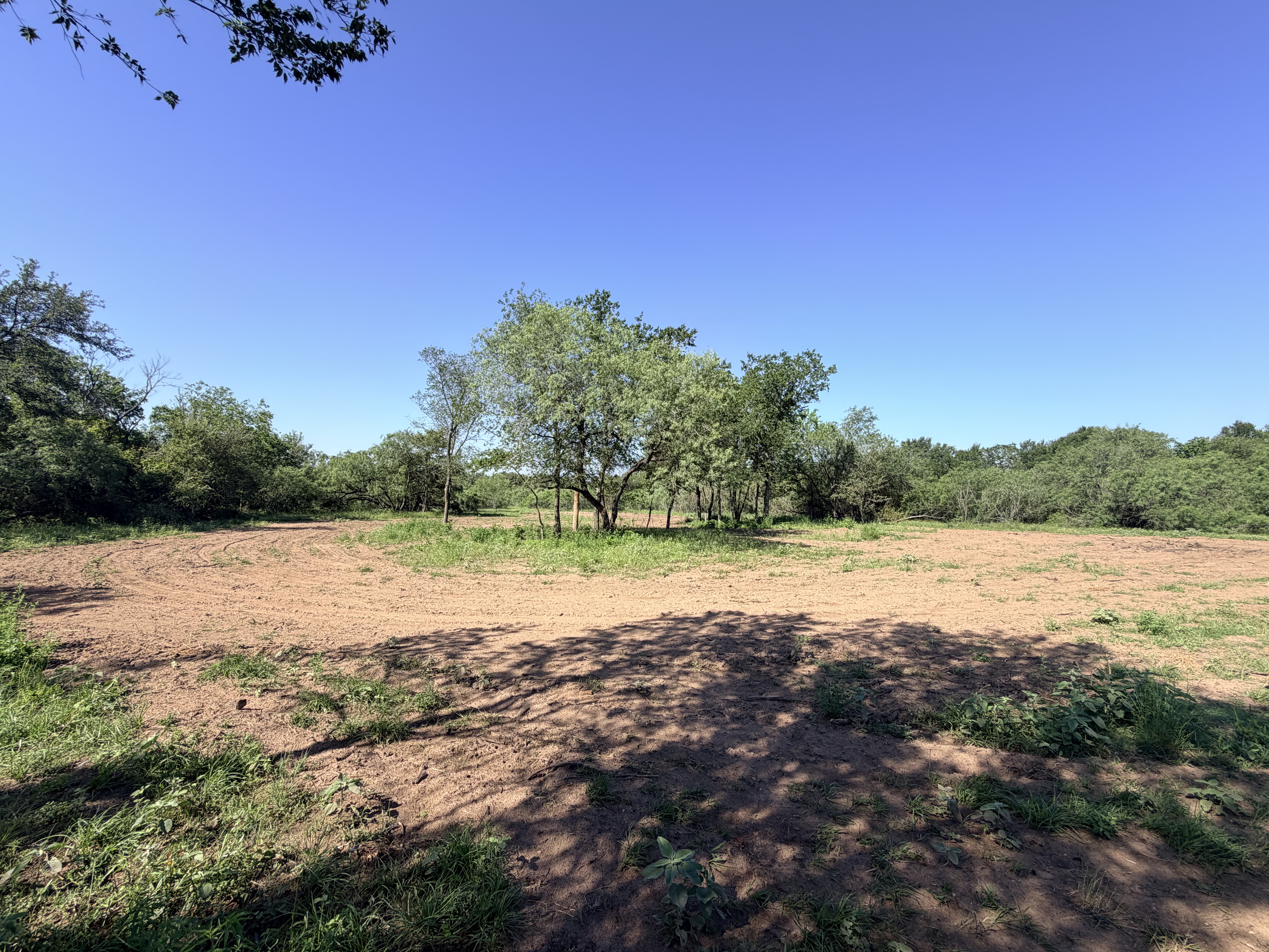 Discover a stunning piece of Central Texas landscape located in Luling, TX. This property offers over 12 acres of land, providing the perfect blend of country living and convenience. Enjoy the serene environment, just minutes from town, while experiencing true rural tranquility. The land boasts enormous shade trees and beautiful creek bottom terrain. Its gentle, sloping topography offers pristine views of the surrounding countryside, making it an ideal spot for those seeking scenic vistas. West Plum Creek runs along the backside of the property, adding to its natural appeal. The property features FM highway frontage, ensuring easy access. Several prime building sites are ready for development, with new fencing and electricity already installed. These improvements make the land immediately usable for various purposes. Situated within 5 minutes of Luling and just 10 minutes from Lockhart, this property provides quick access to nearby towns. It is less than an hour from both Austin and San Antonio, and only about 45 minutes from the Austin International Airport and Circuit of the Americas racetrack. 
NO RESTRICTIONS
AG EXEMPT - WILDLIFE