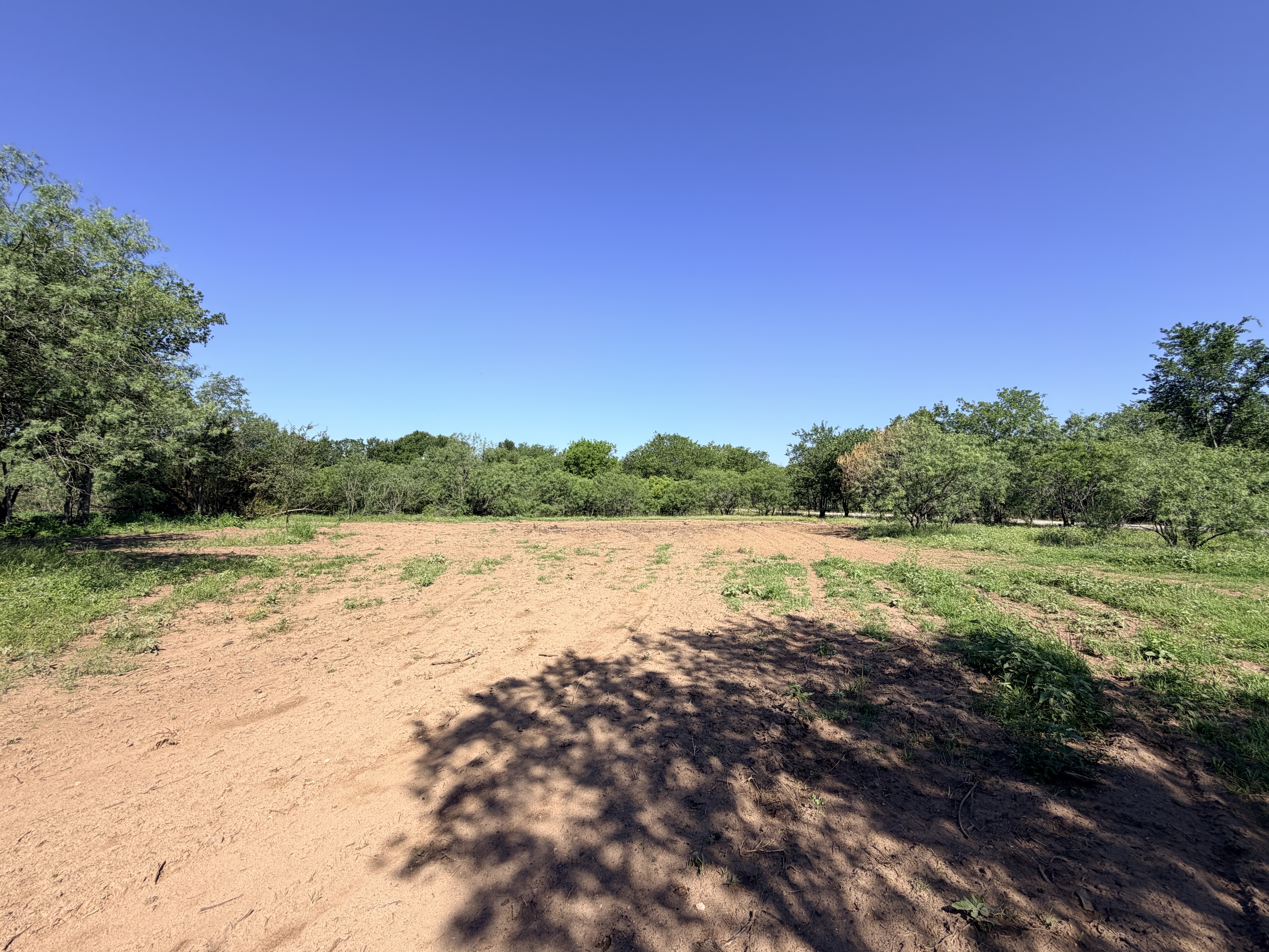 Discover a stunning piece of Central Texas landscape located in Luling, TX. This property offers over 12 acres of land, providing the perfect blend of country living and convenience. Enjoy the serene environment, just minutes from town, while experiencing true rural tranquility. The land boasts enormous shade trees and beautiful creek bottom terrain. Its gentle, sloping topography offers pristine views of the surrounding countryside, making it an ideal spot for those seeking scenic vistas. West Plum Creek runs along the backside of the property, adding to its natural appeal. The property features FM highway frontage, ensuring easy access. Several prime building sites are ready for development, with new fencing and electricity already installed. These improvements make the land immediately usable for various purposes. Situated within 5 minutes of Luling and just 10 minutes from Lockhart, this property provides quick access to nearby towns. It is less than an hour from both Austin and San Antonio, and only about 45 minutes from the Austin International Airport and Circuit of the Americas racetrack. 
NO RESTRICTIONS
AG EXEMPT - WILDLIFE