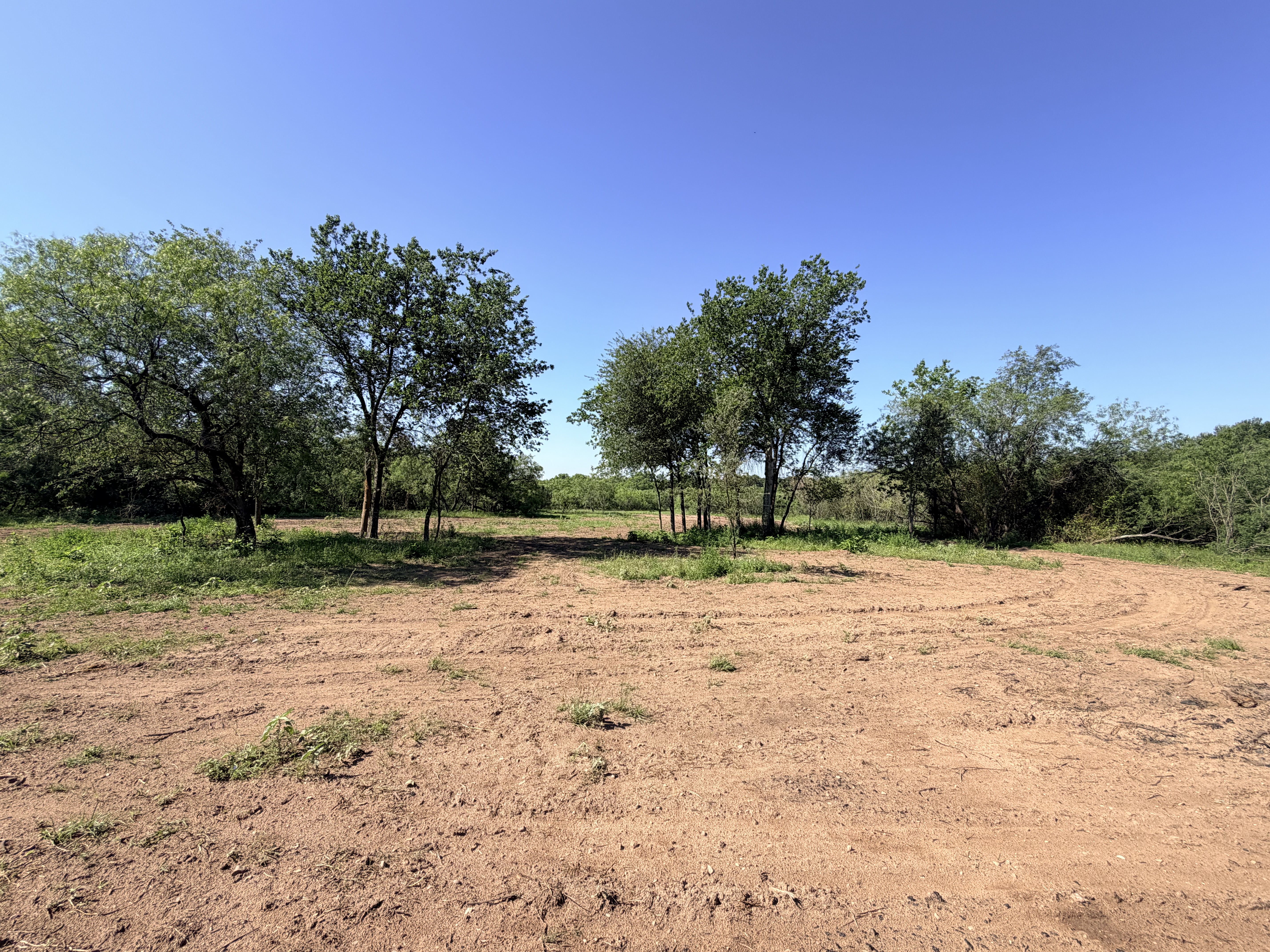 Discover a stunning piece of Central Texas landscape located in Luling, TX. This property offers over 12 acres of land, providing the perfect blend of country living and convenience. Enjoy the serene environment, just minutes from town, while experiencing true rural tranquility. The land boasts enormous shade trees and beautiful creek bottom terrain. Its gentle, sloping topography offers pristine views of the surrounding countryside, making it an ideal spot for those seeking scenic vistas. West Plum Creek runs along the backside of the property, adding to its natural appeal. The property features FM highway frontage, ensuring easy access. Several prime building sites are ready for development, with new fencing and electricity already installed. These improvements make the land immediately usable for various purposes. Situated within 5 minutes of Luling and just 10 minutes from Lockhart, this property provides quick access to nearby towns. It is less than an hour from both Austin and San Antonio, and only about 45 minutes from the Austin International Airport and Circuit of the Americas racetrack. 
NO RESTRICTIONS
AG EXEMPT - WILDLIFE