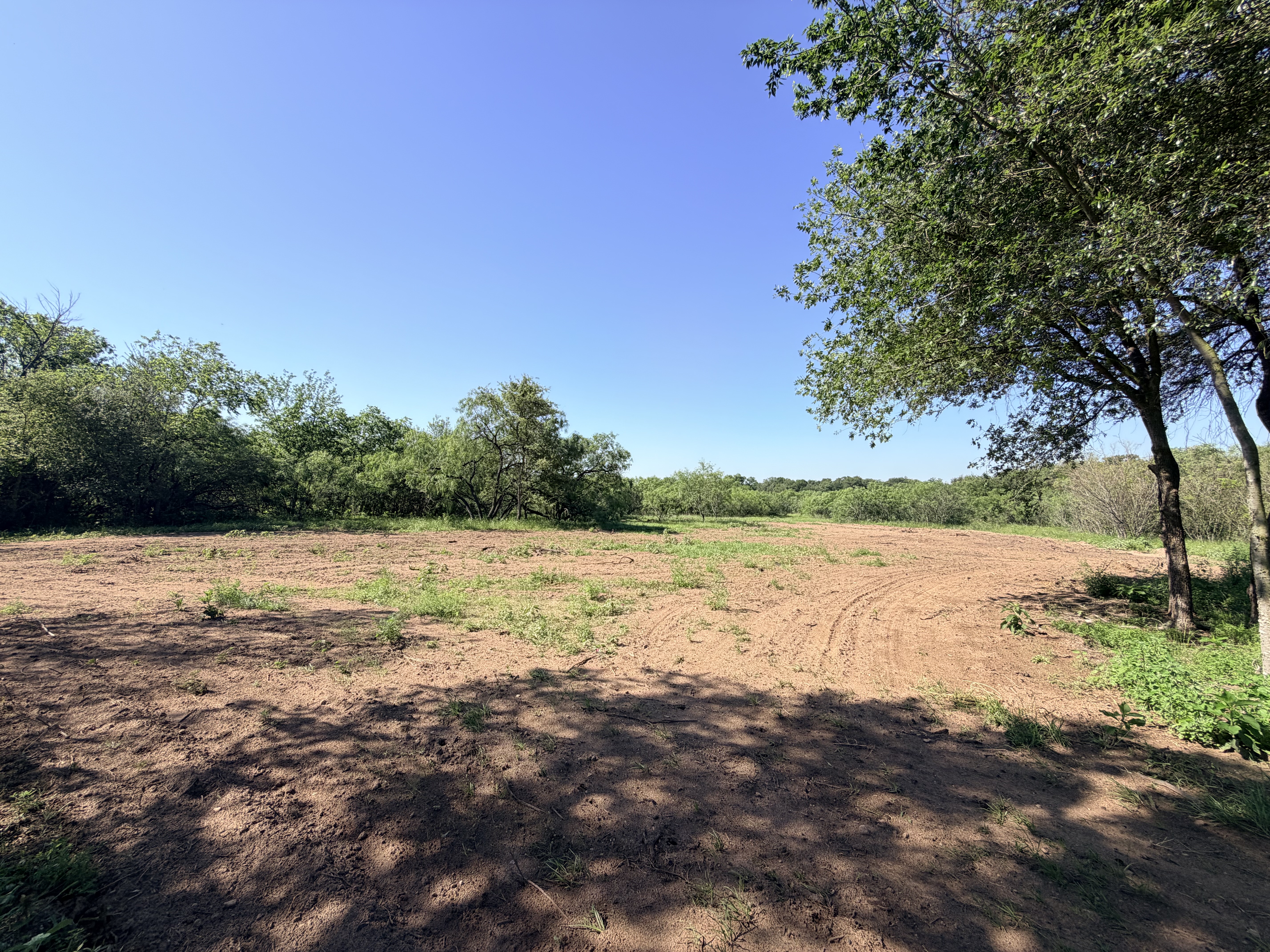 Discover a stunning piece of Central Texas landscape located in Luling, TX. This property offers over 12 acres of land, providing the perfect blend of country living and convenience. Enjoy the serene environment, just minutes from town, while experiencing true rural tranquility. The land boasts enormous shade trees and beautiful creek bottom terrain. Its gentle, sloping topography offers pristine views of the surrounding countryside, making it an ideal spot for those seeking scenic vistas. West Plum Creek runs along the backside of the property, adding to its natural appeal. The property features FM highway frontage, ensuring easy access. Several prime building sites are ready for development, with new fencing and electricity already installed. These improvements make the land immediately usable for various purposes. Situated within 5 minutes of Luling and just 10 minutes from Lockhart, this property provides quick access to nearby towns. It is less than an hour from both Austin and San Antonio, and only about 45 minutes from the Austin International Airport and Circuit of the Americas racetrack. 
NO RESTRICTIONS
AG EXEMPT - WILDLIFE